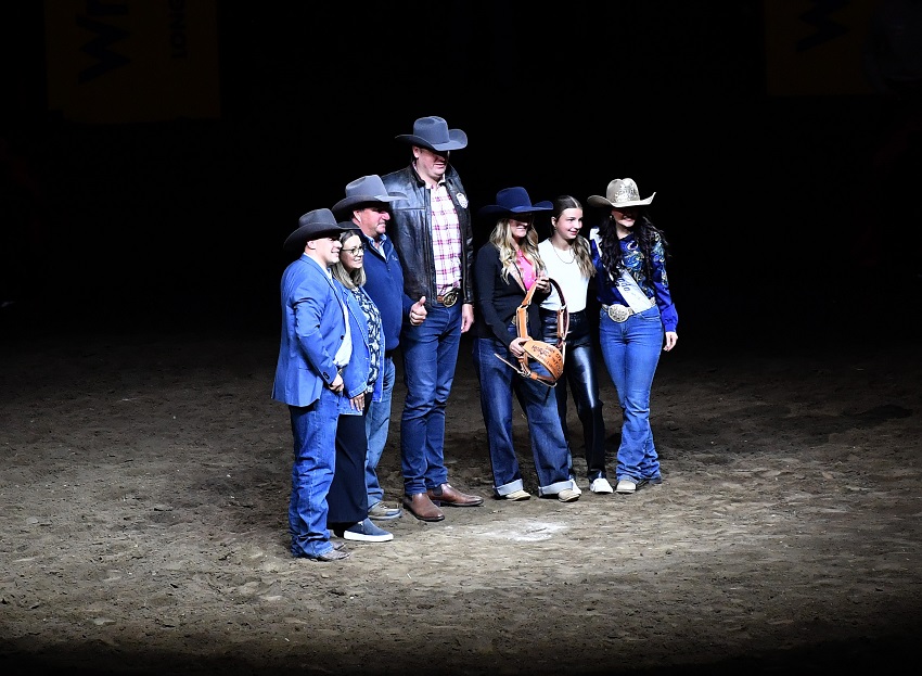 Minister of Tourism and Sport Joseph Schow presents an award at the Canadian Finals Rodeo.