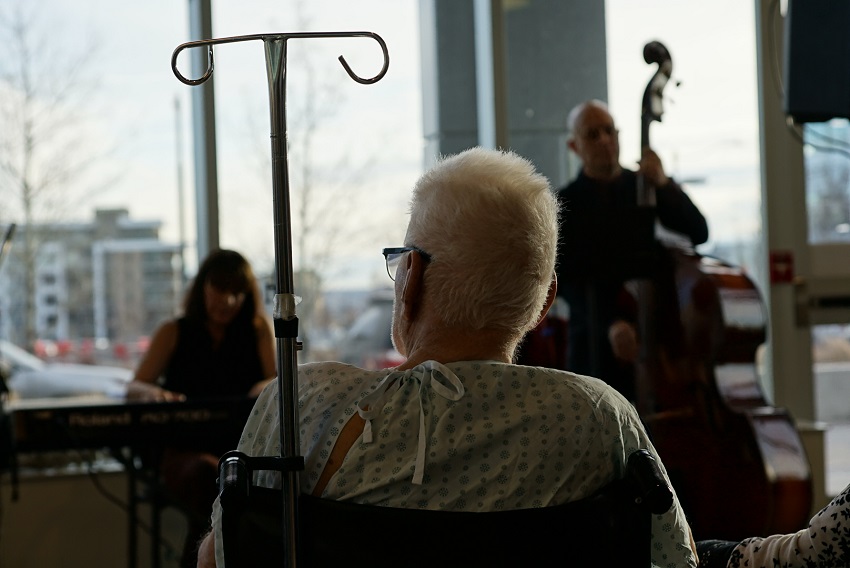 A patient watches local musicians play at the South Health Campus music series pilot project in February of 2024.