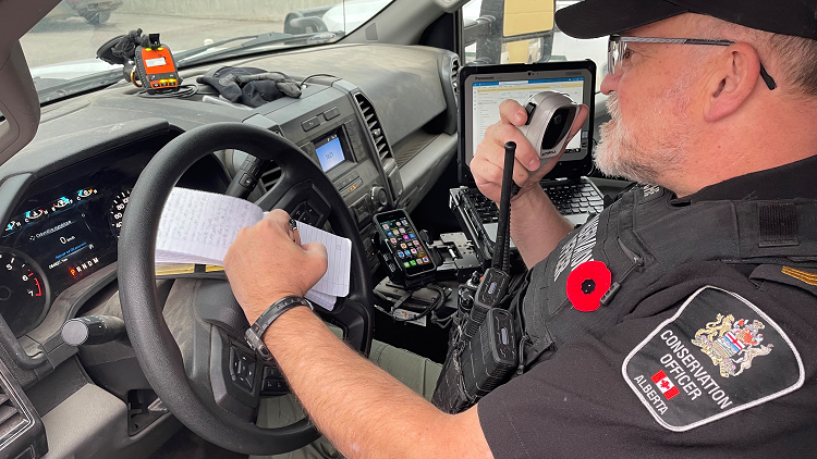 Photo of a conservation officer in their vehicle