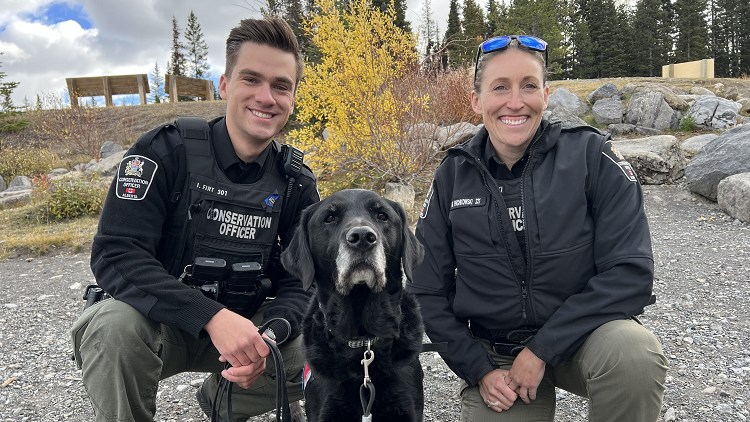 Photo of 2 conservation officers and their dog