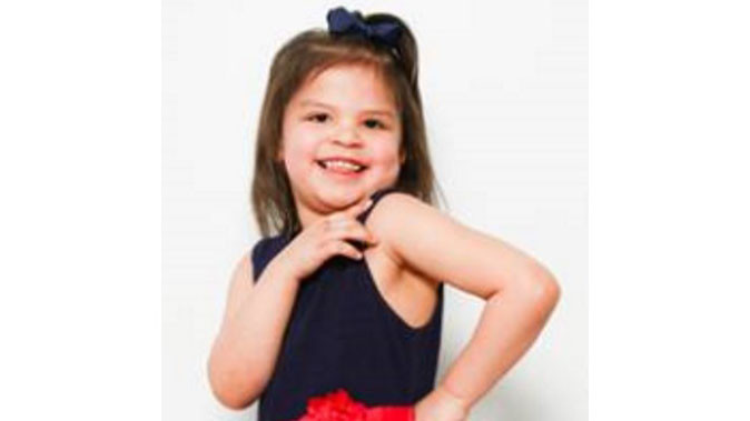 Adoption profile photo of Journey: Young girl with a half ponytail in a black and red dress