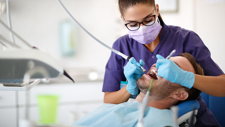 Female dentist working on patient